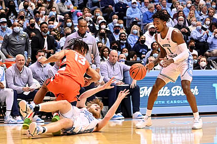 Feb 28, 2022; Chapel Hill, North Carolina, USA; North Carolina Tar Heels forward Brady Manek (45) passes the ball to guard Leaky Black (1) as Syracuse Orange forward Benny Williams (13) defends in the first half at Dean E. Smith Center. Mandatory Credit: Bob Donnan-USA TODAY Sports