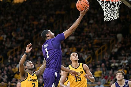 Feb 28, 2022; Iowa City, Iowa, USA; Northwestern Wildcats guard Chase Audige (1) goes to the basket as Iowa Hawkeyes guard Joe Toussaint (2) and forward Keegan Murray (15) look on during the first half at Carver-Hawkeye Arena. Mandatory Credit: Jeffrey Becker-USA TODAY Sports