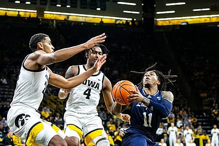 Iowa forward Kris Murray, left, and guard Ahron Ulis (4) defend Longwood's Jordan Perkins (11) during a NCAA non-conference men's basketball game, Tuesday, Nov. 9, 2021, at Carver-Hawkeye Arena in Iowa City, Iowa.

211109 Longwood Iowa Mbb 019 Jpg