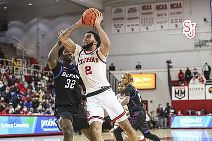 Jan 5, 2022; Queens, New York, USA;  St. John's Red Storm guard Julian Champagnie (2) drives past DePaul Blue Demons forward David Jones (32) in the second half at Carnesecca Arena. Mandatory Credit: Wendell Cruz-USA TODAY Sports