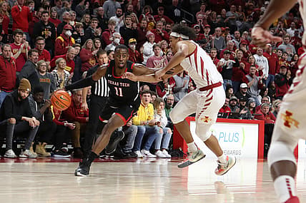 Jan 5, 2022; Ames, Iowa, USA; Texas Tech Red Raiders forward Bryson Williams (11) drives past Iowa State Cyclones forward Robert Jones (12) at James H. Hilton Coliseum. Mandatory Credit: Reese Strickland-USA TODAY Sports