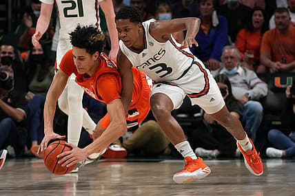 Jan 5, 2022; Coral Gables, Florida, USA; Syracuse Orange center Jesse Edwards (14) and Miami Hurricanes guard Charlie Moore (3) battle for a loose ball during the second half at Watsco Center. Mandatory Credit: Jasen Vinlove-USA TODAY Sports