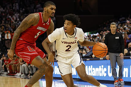 Jan 24, 2022; Charlottesville, Virginia, USA; Virginia Cavaliers guard Reece Beekman (2) drives to the basket as Louisville Cardinals forward Malik Williams (5) defends during the second half at John Paul Jones Arena. Mandatory Credit: Geoff Burke-USA TODAY Sports