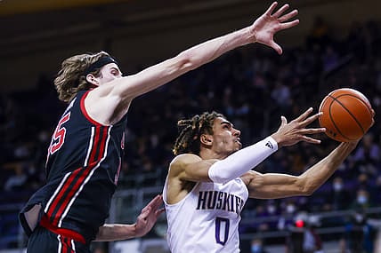 Jan 29, 2022; Seattle, Washington, USA; Washington Huskies forward Emmitt Matthews Jr. (0) moves to the basket against Utah Utes center Branden Carlson (35) during the second half at Alaska Airlines Arena at Hec Edmundson Pavilion. Mandatory Credit: Joe Nicholson-USA TODAY Sports