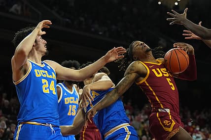 Feb 12, 2022; Los Angeles, California, USA; Southern California Trojans guard Isaiah White (5) battles for the ball against UCLA Bruins guard Jaime Jaquez Jr. (24) and guard Jules Bernard (1) in the first half at Galen Center. Mandatory Credit: Kirby Lee-USA TODAY Sports