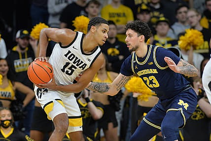 Feb 17, 2022; Iowa City, Iowa, USA; Iowa Hawkeyes forward Keegan Murray (15) controls the ball as Michigan Wolverines forward Brandon Johns Jr. (23) defends during the first half at Carver-Hawkeye Arena. Mandatory Credit: Jeffrey Becker-USA TODAY Sports