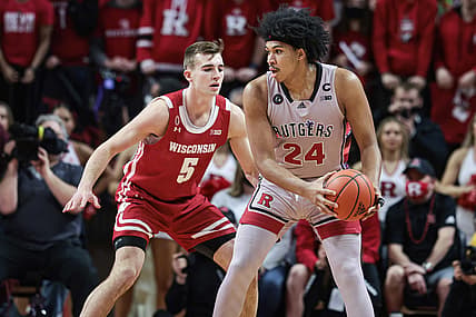 Feb 26, 2022; Piscataway, New Jersey, USA; Rutgers Scarlet Knights forward Ron Harper Jr. (24) shields the ball from Wisconsin Badgers forward Tyler Wahl (5) during the first half at Jersey Mike's Arena. Mandatory Credit: Vincent Carchietta-USA TODAY Sports