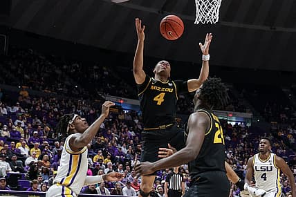 Feb 26, 2022; Baton Rouge, Louisiana, USA;  Missouri Tigers guard Javon Pickett (4) grabs a rebound against LSU Tigers forward Mwani Wilkinson (5) during the second half at the Pete Maravich Assembly Center. Mandatory Credit: Stephen Lew-USA TODAY Sports