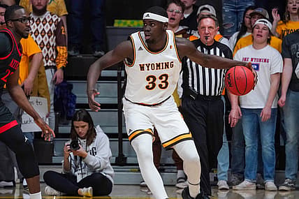 Feb 28, 2022; Laramie, Wyoming, USA; Wyoming Cowboys forward Graham Ike (33) controls the ball against San Diego State Aztecs forward Tahirou Diabate (22) during the first half at Arena-Auditorium. Mandatory Credit: Troy Babbitt-USA TODAY Sports