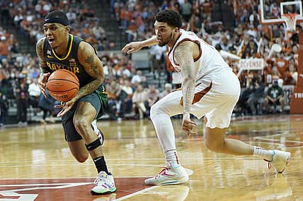 Feb 28, 2022; Austin, Texas, USA; Baylor Bears guard James Akinjo (11) drives to the basket past Texas Longhorns forward Timmy Allen (0) during the second half at Frank C. Erwin Jr. Center. Mandatory Credit: Scott Wachter-USA TODAY Sports