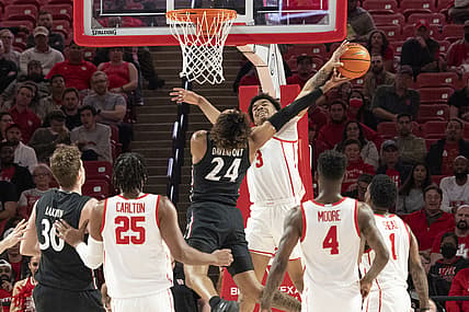 Mar 1, 2022; Houston, Texas, USA;  Houston Cougars guard Ramon Walker Jr. (3) blocks Cincinnati Bearcats guard Jeremiah Davenport (24) shot in the first half at Fertitta Center. Mandatory Credit: Thomas Shea-USA TODAY Sports