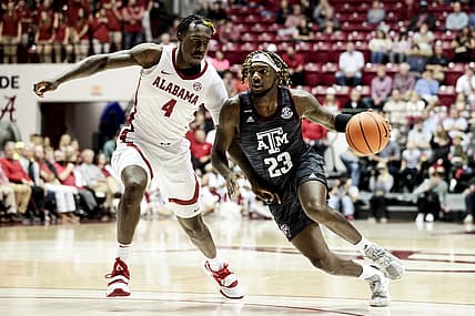 Mar 2, 2022; Tuscaloosa, Alabama, USA; Texas A&M Aggies guard Tyrece Radford (23) dribbles the ball around Alabama Crimson Tide forward Juwan Gary (4) during the first half at Coleman Coliseum. Mandatory Credit: Butch Dill-USA TODAY Sports