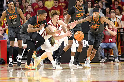 Mar 2, 2022; Ames, Iowa, USA; Iowa State Cyclones forward Aljaz Kunc (5) and Oklahoma State Cowboys guard Bryce Thompson (1) and guard Avery Anderson III (0) play for the ball at James H. Hilton Coliseum. Mandatory Credit: Reese Strickland-USA TODAY Sports