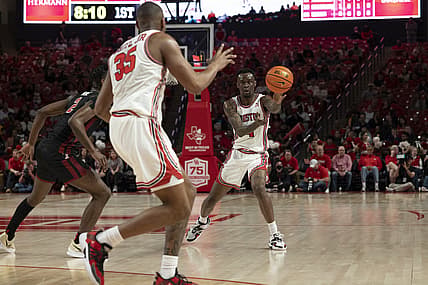 Mar 3, 2022; Houston, Texas, USA;  Houston Cougars guard Taze Moore (4) passes to forward Fabian White Jr. (35) against Temple Owls guard Jahlil White (2) in the first half at Fertitta Center. Mandatory Credit: Thomas Shea-USA TODAY Sports