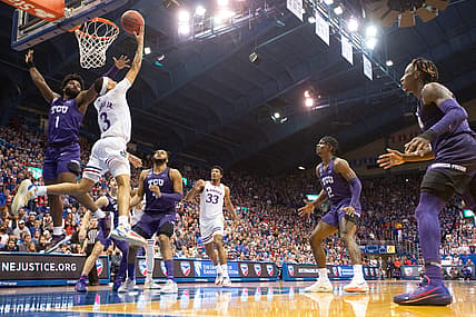 Kansas redshirt sophomore guard Dajuan Harris Jr. (3) scores under the basket in the second half of Thursday's game against TCU inside Allen Fieldhouse.