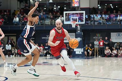Feb 26, 2022; Moraga, California, USA; Saint Mary's Gaels guard Tommy Kuhse (12) dribbles against Gonzaga Bulldogs guard Rasir Bolton (45) during the second half at University Credit Union Pavilion. Mandatory Credit: Darren Yamashita-USA TODAY Sports