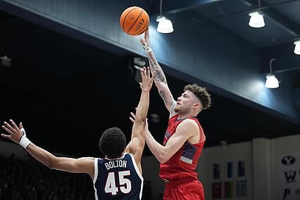 Feb 26, 2022; Moraga, California, USA; Saint Mary's Gaels guard Logan Johnson (0) shoots against Gonzaga Bulldogs guard Rasir Bolton (45) during the second half at University Credit Union Pavilion. Mandatory Credit: Darren Yamashita-USA TODAY Sports