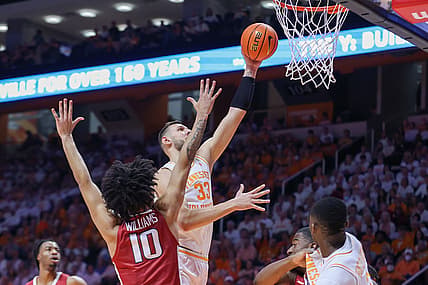Mar 5, 2022; Knoxville, Tennessee, USA; Tennessee Volunteers forward Uros Plavsic (33) goes to the basket against Arkansas Razorbacks forward Jaylin Williams (10) during the first half at Thompson-Boling Arena. Mandatory Credit: Randy Sartin-USA TODAY Sports