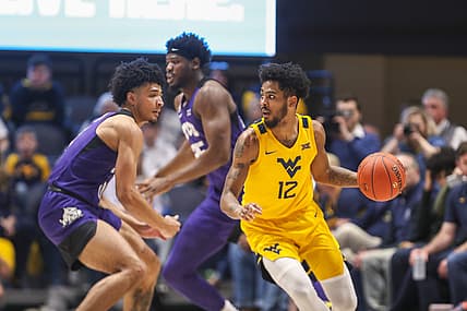 Mar 5, 2022; Morgantown, West Virginia, USA; West Virginia Mountaineers guard Taz Sherman (12) dribbles during the first half against the TCU Horned Frogs at WVU Coliseum. Mandatory Credit: Ben Queen-USA TODAY Sports
