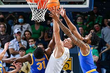 Mar 5, 2022; South Bend, Indiana, USA; Pittsburgh Panthers guard Onyebuchi Ezeakudo (31) Notre Dame Fighting Irish forward Nate Laszewski (14) and Pittsburgh Panthers guard Femi Odukale (2) reach for a rebound in the first half at the Purcell Pavilion. Mandatory Credit: Matt Cashore-USA TODAY Sports