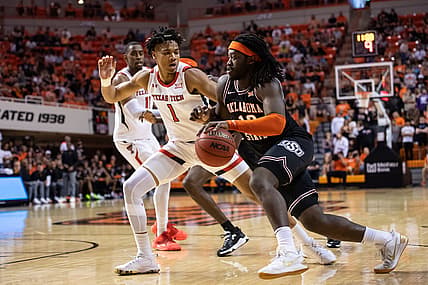 Mar 5, 2022; Stillwater, Oklahoma, USA; Oklahoma State Cowboys guard Isaac Likekele (13) drives to the basket while defended by Texas Tech Red Raiders guard Terrence Shannon Jr. (1) during the first half at Gallagher-Iba Arena. Mandatory Credit: Rob Ferguson-USA TODAY Sports