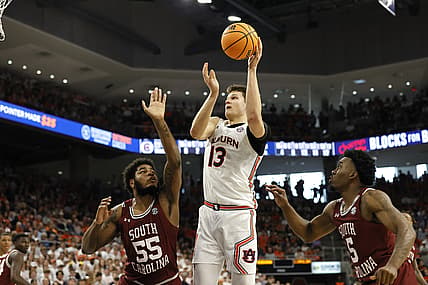 Mar 5, 2022; Auburn, Alabama, USA; Auburn Tigers forward Walker Kessler (13) shoots between South Carolina Gamecocks forward Ta'Quan Woodley (55) and guard Jermaine Couisnard (5) during the second half at Neville Arena. Mandatory Credit: John Reed-USA TODAY Sports