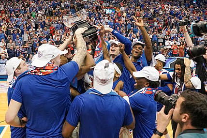 Mar 5, 2022; Lawrence, Kansas, USA; The Kansas Jayhawks players celebrate with the Big12 Trophy after the win over the Texas Longhorns at Allen Fieldhouse. Mandatory Credit: Denny Medley-USA TODAY Sports
