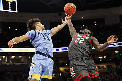 Mar 5, 2022; Milwaukee, Wisconsin, USA;  Marquette Golden Eagles forward Oso Ighodaro (13) and St. John   s Red Storm forward Esahia Nyiwe (22) reach for a rebound during the first half at Fiserv Forum. Mandatory Credit: Jeff Hanisch-USA TODAY Sports