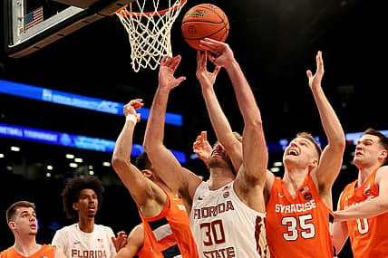 Mar 9, 2022; Brooklyn, NY, USA; Florida State Seminoles forward Harrison Prieto (30) fights for a rebound against Syracuse Orange center Frank Anselem (5) and guard Buddy Boeheim (35) and forward Jimmy Boeheim (0) during the first half at Barclays Center. Mandatory Credit: Brad Penner-USA TODAY Sports