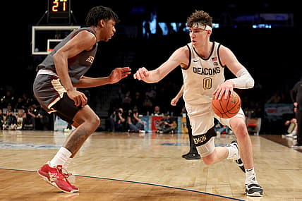 Mar 9, 2022; Brooklyn, NY, USA; Wake Forest Demon Deacons forward Jake LaRavia (0) drives to the basket against Boston College Eagles guard Kanye Jones (4) during the first half at Barclays Center. Mandatory Credit: Brad Penner-USA TODAY Sports