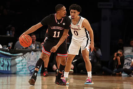 Mar 9, 2022; Brooklyn, NY, USA; Louisville Cardinals guard Mason Faulkner (11) controls the ball against Virginia Cavaliers guard Kihei Clark (0) during the first half at Barclays Center. Mandatory Credit: Brad Penner-USA TODAY Sports