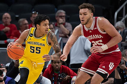Mar 10, 2022; Indianapolis, IN, USA; Michigan Wolverines guard Eli Brooks (55) dribbles the ball while Indiana Hoosiers forward Race Thompson (25) defends in the first half at Gainbridge Fieldhouse. Mandatory Credit: Trevor Ruszkowski-USA TODAY Sports