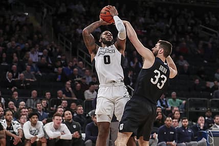 Mar 10, 2022; New York, NY, USA;  Providence Friars center Nate Watson (0) shoots over Butler Bulldogs forward Bryce Golden (33) in the first half at the Big East Conference Tournament at Madison Square Garden. Mandatory Credit: Wendell Cruz-USA TODAY Sports