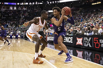 Mar 10, 2022; Kansas City, MO, USA; Texas Christian Horned Frogs forward Chuck O'Bannon Jr. (5) handles the ball while defended by Texas Longhorns guard Courtney Ramey (3) in the first half at T-Mobile Center. Mandatory Credit: Amy Kontras-USA TODAY Sports
