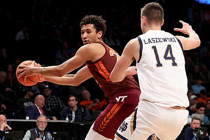 Mar 10, 2022; Brooklyn, NY, USA; Virginia Tech Hokies forward Keve Aluma (22) controls the ball against Notre Dame Fighting Irish forward Nate Laszewski (14) during the first half at Barclays Center. Mandatory Credit: Brad Penner-USA TODAY Sports