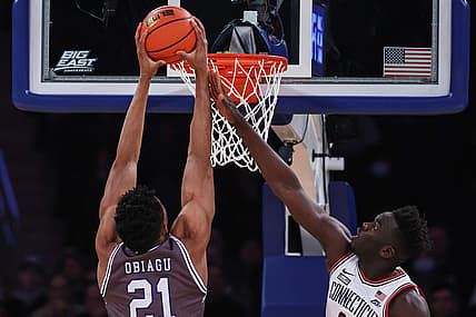 Mar 10, 2022; New York, NY, USA; Seton Hall Pirates center Ike Obiagu (21) shoots the ball as Connecticut Huskies forward Adama Sanogo (21) defends during the first half at Madison Square Garden. Mandatory Credit: Vincent Carchietta-USA TODAY Sports