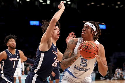 Mar 10, 2022; Brooklyn, NY, USA; North Carolina Tar Heels forward Armando Bacot (5) controls the ball against Virginia Cavaliers forward Kadin Shedrick (21) during the first half at Barclays Center. Mandatory Credit: Brad Penner-USA TODAY Sports