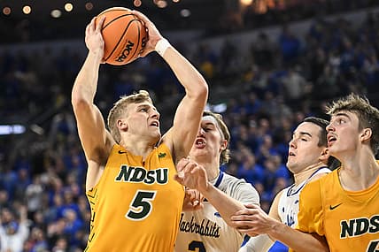 Mar 8, 2022; Sioux Falls, SD, USA;  North Dakota State Bison guard Sam Griesel (5) scores against South Dakota State Jackrabbits guard Baylor Scheierman (3) in the second half at Denny Sanford Premier Center. Mandatory Credit: Steven Branscombe-USA TODAY Sports