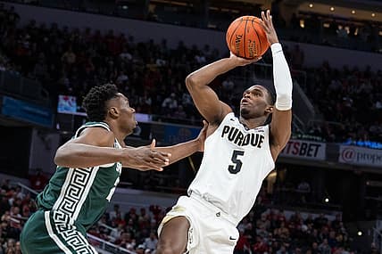Mar 12, 2022; Indianapolis, IN, USA;  Purdue Boilermakers guard Brandon Newman (5) shoots the ball while Michigan State Spartans center Mady Sissoko (22) defends in the first half at Gainbridge Fieldhouse. Mandatory Credit: Trevor Ruszkowski-USA TODAY Sports