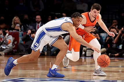 Mar 12, 2022; Brooklyn, NY, USA; Duke Blue Devils forward Wendell Moore Jr. (0) and Virginia Tech Hokies guard Hunter Cattoor (0) fight for a loose ball during the first half of the ACC Men's Basketball Tournament final at Barclays Center. Mandatory Credit: Brad Penner-USA TODAY Sports