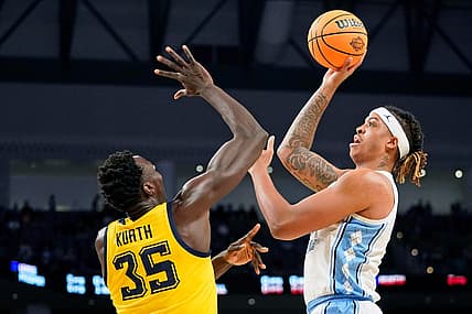 Mar 17, 2022; Fort Worth, TX, USA; North Carolina Tar Heels forward Armando Bacot (5) shoots the ball against Marquette Golden Eagles forward Kur Kuath (35) during the first half during the first round of the 2022 NCAA Tournament at Dickies Arena. Mandatory Credit: Chris Jones-USA TODAY Sports