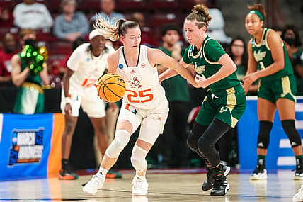 Mar 18, 2022; Columbia, South Carolina, USA; Miami Hurricanes guard Karla Erjavec (25) drives around South Florida Bulls guard Elisa Pinzan (4) in the second quarter at Colonial Life Arena. Mandatory Credit: Jeff Blake-USA TODAY Sports