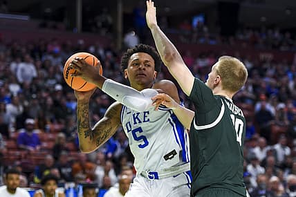 Mar 20, 2022; Greenville, SC, USA; Duke Blue Devils forward Paolo Banchero (5) carries the ball against Michigan State Spartans forward Joey Hauser (10) in the first half during the second round of the 2022 NCAA Tournament at Bon Secours Wellness Arena. Mandatory Credit: Bob Donnan-USA TODAY Sports