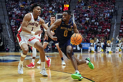 Mar 20, 2022; San Diego, CA, USA; Notre Dame Fighting Irish guard Blake Wesley (0) drives against Texas Tech Red Raiders guard Terrence Shannon Jr. (1) in the first half during the second round of the 2022 NCAA Tournament at Viejas Arena. Mandatory Credit: Kirby Lee-USA TODAY Sports