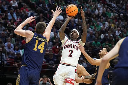 Mar 20, 2022; San Diego, CA, USA; Texas Tech Red Raiders guard Davion Warren (2) shoots against Notre Dame Fighting Irish forward Nate Laszewski (14) and guard Prentiss Hubb (3) in the second half during the second round of the 2022 NCAA Tournament at Viejas Arena. Mandatory Credit: Kirby Lee-USA TODAY Sports