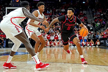 Mar 24, 2022; San Antonio, TX, USA; Houston Cougars guard Kyler Edwards (11) drives to the basket against Arizona Wildcats guard Dalen Terry (4) during the first half in the semifinals of the South regional of the men's college basketball NCAA Tournament at AT&T Center. Mandatory Credit: Daniel Dunn-USA TODAY Sports