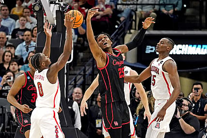 Mar 24, 2022; San Antonio, TX, USA; Arizona Wildcats guard Bennedict Mathurin (0) and Houston Cougars center Josh Carlton (25) go for the ball during the second half in the semifinals of the South regional of the men's college basketball NCAA Tournament at AT&T Center. Mandatory Credit: Scott Wachter-USA TODAY Sports