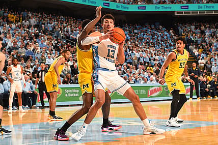 Dec 1, 2021; Chapel Hill, North Carolina, USA;  North Carolina Tar Heels forward Dawson Garcia (13) with the ball as Michigan Wolverines forward Moussa Diabate (14) defends in the second half at Dean E. Smith Center. Mandatory Credit: Bob Donnan-USA TODAY Sports