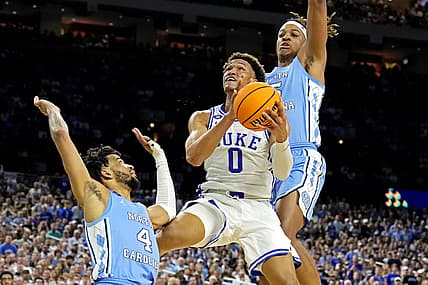 Apr 2, 2022; New Orleans, LA, USA; Duke Blue Devils forward Wendell Moore Jr. (0) drives to the basket against North Carolina Tar Heels guard R.J. Davis (4) and North Carolina Tar Heels forward Armando Bacot (5) during the second half in the 2022 NCAA men's basketball tournament Final Four semifinals at Caesars Superdome. Mandatory Credit: Robert Deutsch-USA TODAY Sports