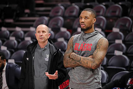 Feb 7, 2020; Salt Lake City, Utah, USA; Portland Trail Blazers guard Damian Lillard (0) talks with his Weber State head coach Randy Rahe before the game against the Utah Jazz at Vivint Smart Home Arena. Mandatory Credit: Chris Nicoll-USA TODAY Sports